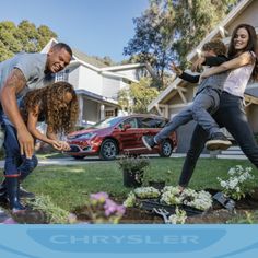 three people are in the yard with flowers and plants