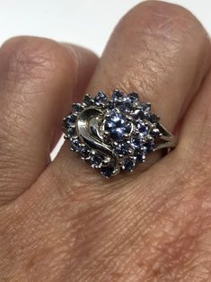 Vintage Handmade Blue Tanzanite Setting 925 Sterling Silver Gothic Ring https://www.etsy.com/listing/501387365/vintage-handmade-blue-tanzanite-setting?utm_source=crowdfire&utm_medium=api&utm_campaign=api Sapphire Cluster Jewelry For Anniversary, Fine Jewelry Sapphire Cluster Ring As Gift, Cluster Jewelry With Accent Stones For Gifts, Blue Multi-stone Rings For Gifts, Blue Multi-stone Rings For Gift, Cluster Ring With Accent Stones For Gift, Gift Sapphire Cluster Ring, Unique Blue Jewelry For Anniversary, Fine Jewelry Cluster Gift