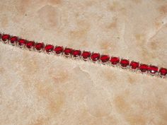 "Beautiful Red 133.00 Carats of Brazilian Red Ruby 6mm Round Cut Gemstones,18K White Gold Filled 7 1/2\" Inch Tennis Bracelet. FREE SHIPPING in the USA, $11 Everywhere else, it costs me $14.83 to ship to other countries, so I have to recover some of this cost. **Matching Earrings in Earring Section of Shop. **The Gemstones are from the Upper Crust of the mine and are not as good a quality as the gemstones deeper down, they have not has as many million years of earth's pressure to be the very bes Silver 925 Necklace, Ruby Gemstone, Red Ruby, Garnet Gemstone, Red Garnet, Tennis Bracelet, Bracelet Sizes, Matching Earrings, Arm Band