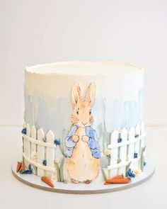 a cake decorated with an image of a rabbit holding a carrot on top of it