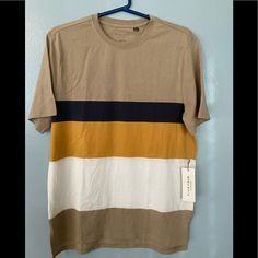 Brand New With Tags. Size Medium Striped Beige T-Shirt. Stripe Colors Are White, Mustard, And Navy Blue. The Back Of The Shirt Drops A Little Longer Than The Front. Shown In Photos. Casual Color Block Crew Neck T-shirt, Summer Color Block Crew Neck T-shirt, Short Sleeve Cotton Color Block Shirt, Short Sleeve Color Block Cotton Shirt, Striped Cotton Crew Neck Shirt, Casual Cotton Color Block Shirt, Casual Color Block Cotton Shirt, Summer Color Block Brown Tops, Summer Brown Color Block Tops