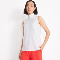 Made of super-soft cotton/modal, a highly breathable blend resistant to wrinkles, fading, shrinkage and pilling, wash after wash, this versatile sleeveless mock neck is a closet must-have. Wear it with shorts and a pair of sandals during the warmer months, then layer it under a cozy cardigan when the temperatures cool down. High Stretch Cotton Sleeveless Top, High Stretch Sleeveless Cotton Top, White High Neck Cotton Top, White High Neck Tank Top For Spring, Sporty High Neck Summer Tops, High Neck Cotton Tank Top For Summer, Summer High Neck Cotton Tank Top, White High Neck Tank Top Casual, High Neck Athleisure Tank Top For Summer