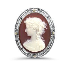 The 14K yellow and white gold Victorian cameo brooch is an elegant and timeless piece. It features a beautifully carved red agate cameo portrait, measuring 36x28mm, which is securely bezel set in a milgrained mounting. The intricate milgrained open-worked filigree frame adds to its antique charm and sophistication. Enhancing its beauty, the brooch is adorned with four 2.3mm seed pearls positioned at the north, south, east, and west points, adding a touch of classic elegance. Measuring 45x36mm, t Elegant Oval Intaglio Brooches, Heirloom Cameo Brooches For Formal Occasions, Heirloom Style Cameo Brooch For Formal Occasions, Heirloom Cameo Brooch For Formal Occasions, White Oval Cameo Brooches, White Cameo Brooches For Formal Occasion, White Cameo Brooch For Formal Occasions, Ornate Cameo Brooches For Anniversary, Carved Oval Brooches For Formal Wear