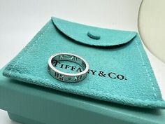 <p>Tiffany Co 18k White Gold Diamond Pierced Atlas Band Ring Roman Numeral Size 4.5. </p><br /><p>Markings: T&Co AU 750 </p><p>Stones: Diamonds - melee x4</p><p>Size: 4.5</p><br /><p>Tiffany pouch and box are included </p> Designer Open Ring Formal Jewelry, Designer Open Ring For Formal Occasions, Designer Open Ring Jewelry For Formal Occasions, Designer Formal Open Ring Jewelry, Luxury Aaa Quality Rings For Formal Occasions, Luxury White Gold Rings With Hallmarks, Designer Oval White Gold Ring, Luxury Engraved Ring With Vs Clarity, Designer Silver Jewelry With Hallmarks