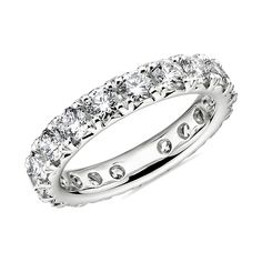 a white gold ring with rows of round brilliant cut diamonds on the inside and outside