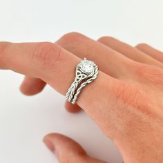 a person's hand with a ring on it