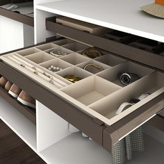 an open drawer in the middle of a kitchen