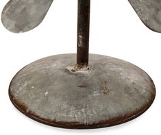 an umbrella stand with three metal leaves on it