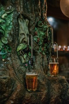 two glasses filled with liquid sitting on top of a tree