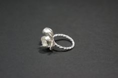 -Product description- Handmade sterling silver (925) jasmine ring. The ring shank is handmade with twisted and beaded wire. The inner surface of the jasmine petal was carefully hand textured to be shimmery. While the outer layer was smooth and shiny, to give a beautiful contrast. A freshwater pearl was then attached to give an elegant touch. Great as a gift for her, or a treat for yourself. The jasmine blossom and bud part are about 25mm in length (1 inch) and 17mm (11/16 inch) in width, weighin Adjustable Delicate Silver Pearl Ring, Delicate Silver Pearl Ring Gift, Elegant Adjustable Sterling Silver Flower Ring, Handmade Delicate Silver Flower Ring, Handmade Delicate Flower Ring In Sterling Silver, Delicate Handmade Silver Flower Ring, Elegant Handmade White Gold Flower Ring, Handmade Sterling Silver Flower Ring For Wedding, Handmade Elegant Silver Flower Ring