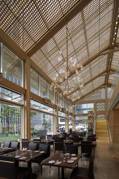 an empty restaurant with tables and chairs in front of large windows