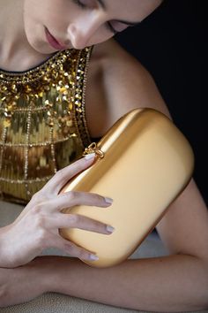 Jeffrey Levinson elina clutch in gold. 24K Yellow Gold, Hand-stitched Italian lambskin interior, Ceramic Hardshell Exterior Detachable cross-body serpentine chain with 23 in. drop, Two interior pockets with tension-snap closure Made in USA Luxury Clutch With Chain Strap For Galas, Luxury Clutch With Chain Strap For Gala, Luxury Gold Clutch With Chain Strap, Luxury Gold Clutch With Gold-tone Hardware, Gold Clutch With Gold-tone Hardware For Formal Occasions, Gold Clutch With Gold-tone Hardware For Formal Events, Formal Gold Clutch With Gold-tone Hardware, Elegant Yellow Gold Evening Bag, Gold Clutch Evening Bag With Chain Strap