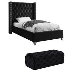 a bed with black velvet upholstered headboard and footstool next to it