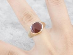 This beautiful antique mounting is crafted of rose gold, a warm color created by alloying with copper. This beautiful styled ring could be for a man or a woman, and has simple engraving on the sides and a warm rich Carnelian center. Carnelian is the reddish-orange version of Chalcedony, and can either be uniformly colored or have visible bands through the stone. Metal: 14K Yellow Gold Gem: Carnelian Gem Measurements: 9.2 x 12 mm, Curved Cut Oval Ring Size: 7.25 Marks: "14" Stamped on the inside Classic Oval Brown Ring, Classic Brown Oval Ring, Round Rose Gold Signet Ring With Gemstone, Classic 14k Gold Brown Ring, Classic Brown Hallmarked Rings, Classic Brown Signet Ring For Anniversary, Classic Brown Rings With Polished Finish, Brown Polished Finish Signet Ring For Formal Occasions, Classic Brown Gemstone Rings