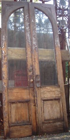 an old wooden double door with glass panels