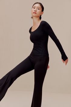 Let every motion flow as easy as your breath in this Ballet Longsleeve T-Shirt - tailored in a flexible, breathable blend to support & enhance your movement as you go through your dance or workout routine. This item is FINAL SALE and cannot be returned or exchanged. Details Materials & Care Shipping & Returns • Slim-fitting, comfortable, yet minimalist-chic design.• Durable, breathable nylon-Spandex fabric blend.• Designed for ballet/dance, yoga, or any activity. • Materials: 81% nylon, 19% Span Elastane Tops For Pilates With 4-way Stretch, Four-way Stretch Top With Thumbholes, Elastane Tops With 4-way Stretch For Pilates, Versatile Breathable Tops, Versatile Breathable Elastane Tops, Solid Color Moisture-wicking Elastane Tops, Solid Moisture-wicking Elastane Tops, Functional Black Elastane Top, Breathable 4-way Stretch Tops For Pilates