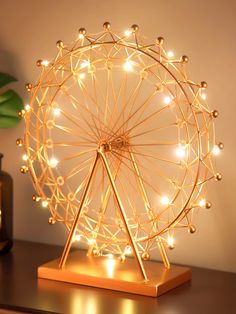 an illuminated ferris wheel on a wooden table