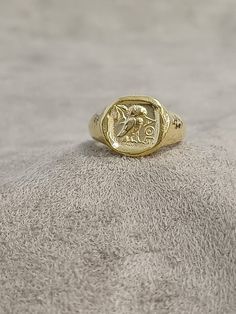 Gold Owl Signet Ring, 10k 14k 18k Solid Gold Jewelry, Handmade Greek Coin Ring, Intaglio Ring for Men, Gold Signet Ring, Valentines Day Gift ★Item Details * Gender : Female / Male  * Material: 10K - 14K - 18K Gold * Ring Diameter: 1.7cm (0.6inches)  * Ring Weight:  10K: 11.50 - 12.00 Gr 14K: 12.50 - 13.00 Gr 18K: 13.50 - 14.00 Gr * All our products are handmade and weights may vary   (-) 1,00 gram  * Ring Size: 5 US to 15 US - ( Contact me if you're expecting to buy another ring size ) * Visit our shop for more items https://www.etsy.com/shop/7SAtelier  ✔ Ready to Ship in 3-5 Business Days ✔ Free shipping worldwide! ✔ The product will be sent in a bubble-wrapped handmade wooden box to avoid any damage during shipping. ✔ Visit our store, browse our other collections, and find the perfect pi 14k Gold Intaglio Signet Ring For Anniversary, 14k Yellow Gold Signet Ring With Intaglio, Gold 14k Signet Ring With Intaglio, Gold 14k Intaglio Signet Ring, Gold Coin Signet Ring For Gift, Gold Coin Shaped Signet Ring For Gift, Ring For Men Gold, Vintage Coin Signet Ring For Gift, Antique Hand-cast Signet Ring For Gift