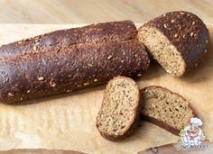 two loaves of bread sitting on top of a cutting board