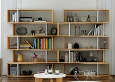 a living room filled with lots of bookshelves next to a white couch and table