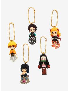 four keychais with anime characters on them in different colors and sizes, one is black