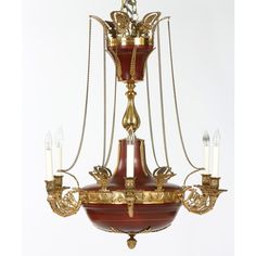 an antique chandelier with four candles hanging from it