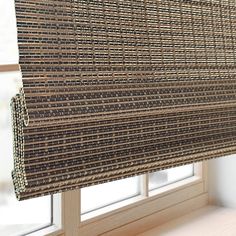 a close up of a window with a blind made out of woven material on it