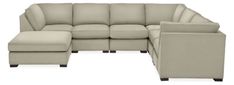 a large sectional couch sitting next to a footstool