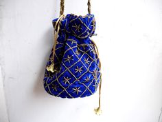 "Velvet evening purse with handwork of golden beads. Crossbody party bag with drawstring at the closure. It has an ethnic Indian touch in style and will go with western wears also like with dresses, jeans, etc. The bag is made up of velvet cloth in different color. It has a sling to hang it on the go. Can be used to gift some one or as fancy small sling bag in party or wedding. It can carry small things like mobile, wallet, etc. Dimension: maximum vertical length (of purse): 7\" vertical length Rectangular Potli Bag For Party Festivals, Traditional Beaded Evening Bag For Festivals, Festival Beaded Pouch Potli Bag, Beaded Shoulder Bag For Festivals Gift, Festival Beaded Potli Bag As A Gift, Beaded Pouch Shoulder Bag For Festive Occasions, Handmade Shoulder Bag For Festival Gift, Beaded Pouch Potli Bag For Festivals, Beaded Bags For Gifts And Festivals