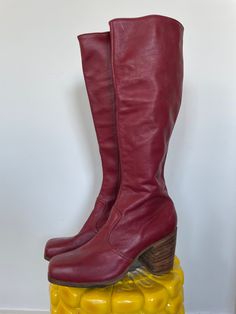 "ITEMS PURCHASED BETWEEN 11/20-1130 WILL SHIP 12/1  Andy from JJ Flash would fly to England and have these boots custom made.  As is, no returns. See full description and images. Description:  Iconic early 1970s boots. Deep red leather throughout, and lined in solid brown leather. Interior zipper and wooden stacked block heel with a square toe. Printed inside is the iconic JJ Flash label, \"Made in England\" printed below it.  Damage notes: Wear consistent with age. Really great condition. Some Red Boots Vintage, Red Leather Knee High Boots, Vintage Boots With Leather Sole And Square Toe, Retro Knee-high Winter Boots, Retro Leather Knee-high Boots With Round Toe, Retro Knee-high Leather Boots, Retro Leather Boots With Square Toe, Retro Square Toe Leather Boots, Retro Wide Calf Knee-high Boots