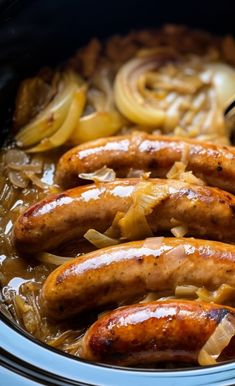 three sausages and onions in a slow cooker