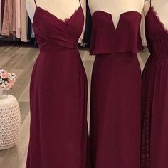 three bridesmaid dresses on mannequins in a store