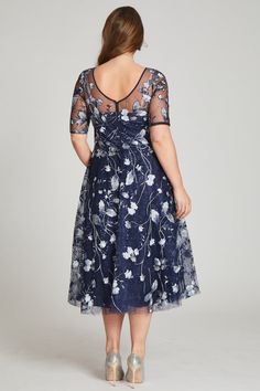 Perfect for cocktail attire events or black tie wedding, this tulle tea length navy and multicolored floral embroidered dress is both flattering and fun. The sheer illusion neckline elongates the torso and the a-line skirt narrows the waist. The light airy fabric makes dancing the night away a breeze. Tea length Elbow length sleeves Illusion neckline Pair with diamond or sapphire jewelry Fit: True to size Length: Knee to Tea length Undergarments: May be worn with any standard bra Black Tie Wedding Guest Dress Spring, Tea Length Formal Dresses, Tulle Cocktail Dress, Tea Length Bridesmaid Dresses, Plus Size Gowns, Cocktail Attire, Floral Embroidered Dress, Embroidered Tulle, Illusion Neckline