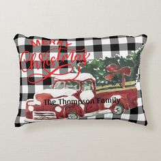 a red and black plaid christmas pillow with an old truck