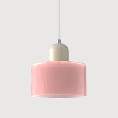 a pink and white light hanging from a ceiling