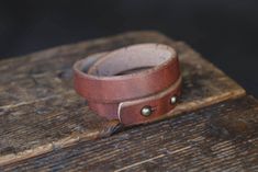 We went bigger and tougher than our standard Double Wrap Cuff, and now we're offering it in the same beefy leather we use on our popular Mountain Belt. Colors may vary, as this waxed leather has many different shades. Expect leather to darken a lot over time and wear. ... 1/2 inch wide, 9oz thick, and fits about a 7" wrist comfortably. Harness leather from Hermann Oak Tannery, St Louis USA Solid brass studs are hand hammered in to stay. Edges are burnished for comfort. Hammered Brass, Card Wallet, Belt Buckles, St Louis, And Now, Solid Brass, Leather Bracelet, Unique Items Products, Bag Lady