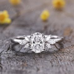 an oval diamond engagement ring with three pear shaped diamonds