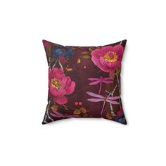 a purple pillow with pink flowers and dragonflies on it