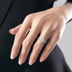 a woman's hand with a diamond ring on it