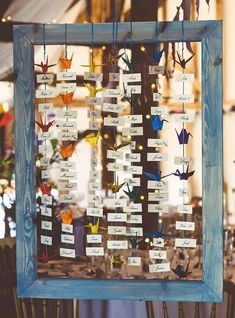 a group of birds hanging from a wooden frame