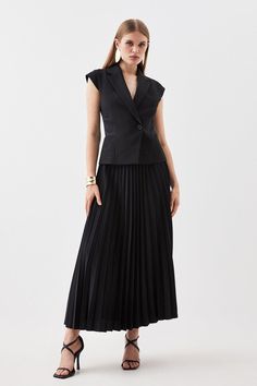 This expertly-crafted garment combines the fluidity of soft pleats with the directional aesthetic of a tailored blazer. Notched lapels provide a directional touch, while soft pleats cascade down to just below the knee. Style this midi dress with heels for a sophisticated look.Compact stretch fabricPleated skirtSleeveless design