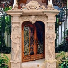 an ornate entrance to a building with statues on it