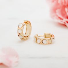 Lined with a series of round mother of pearls, these gold huggies are an understated accent piece you'll adore. Shop a sweet set of earrings today. Available in 14k gold plated brass Hoop size: 3/8" Hoop width: 4mm 3mm mother of pearl Hinged closure Made in the USA SKU: BYE1082 Dainty White Round Huggie Earrings, White 14k Gold Filled Huggie Earrings, Hypoallergenic White Huggie Earrings Gold-plated, Dainty White 14k Gold Filled Huggie Earrings, White Gold Plated Hypoallergenic Hoop Earrings, White Gold-plated Hypoallergenic Hoop Earrings, Small Hoop White Huggie Earrings In 14k Gold, Hypoallergenic White Gold Plated Hoop Earrings, White Tarnish Resistant Small Hoop Huggie Earrings