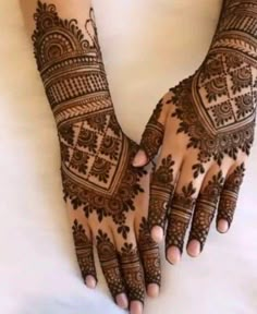 two hands with henna tattoos on them