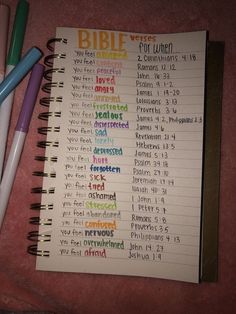 a notebook with the words bible written on it and three pens next to it, all in different colors