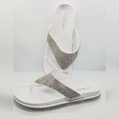 Rhinestone Embellished Thong Sandal Summer Rhinestone Toe Post Flip Flops, Summer Toe Post Flip Flops With Rhinestones, Spring Rhinestone Synthetic Flip Flops, Bedazzled Silver Sandals For The Beach, Silver Bedazzled Sandals For Beach, Silver Bedazzled Sandals For The Beach, White Synthetic Sandals With Rhinestones, White Rhinestone Sandals For Vacation, Bedazzled Synthetic Sandals For Summer