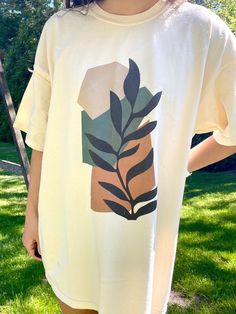 "Comfort Colors ivory t-shirt with an abstract, boho design. Model is 5'4\" and wearing a size XL for an oversized look. 100% cotton." Cotton Graphic Tee With Abstract Print, Oversized Beige T-shirt With Graphic Print, Oversized Bohemian Cotton T-shirt, Bohemian Oversized Cotton T-shirt, Artistic Cotton T-shirt With Abstract Print, Cotton T-shirt With Abstract Print In Relaxed Fit, Summer Beige T-shirt With Screen Print, Beige Screen Print T-shirt For Summer, Oversized Cream Tops With Graphic Print