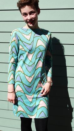 This lovely vintage dress is made by Saks Fifth Avenue, and has great 1970s style with its teal background and geometric print. It's in excellent vintage condition, with no stains or holes, and has been hemmed slightly at the sleeves and hem to make it a perfect fit for a modern Petite Small or ladies' XS. It's made out of a lightweight polyester material with some stretch and has its original label on the back of the neckline. Measurements laid flat: Shoulder to shoulder: 18" Armpit to armpit: 17" Front to bottom hem: 33.5" Back to bottom hem: 34" SHoulder to cuff: 19" Armpit to cuff: 16" Note that our shipping prices include tracking, insurance, and assume "worst-case" - i.e., to the West Coast from our East Coast shop - we refund overestimations on shipping as per our Shipping Policies. Retro Green Dress With Vintage Print, Retro Printed Midi Dress, Retro Fitted Dress With Geometric Pattern, Retro Spring Dresses With Abstract Print, Fitted Retro Dress With Geometric Pattern, Retro Vintage Print Patterned Dress, 1970s Retro Print Long Sleeve Dress, Retro Spring Dress With Geometric Pattern, Retro Patterned Dress With Vintage Print