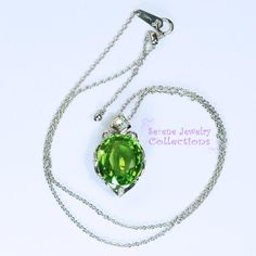 Very pretty Peridot pendant necklace, set with diamonds and in platinum. This peridot is fine quality and a large 13.62 carats in weight and very gemmy clean! The necklace is 18 inch maximum adjustable to any smaller length. A few diamonds adorn the sides of the peridot.Total Weight: 11.71 gramsFace Size: 1 inch x 0.7 inchPrecious Metal: Platinum (pendant and chain necklace)Precious stones:-Peridot Center Stone: 13.62 carats, 16mm x 13.8mm-White Diamonds: 0.29 caratsHallmarks: Pt900, 13.62, D.29 Green Diamond Necklace For Formal Occasions, Formal Green Hallmarked Diamond Necklace, Formal Green Gemstone Diamond Necklace, Hallmarked Green Diamond Necklace, Exquisite Green Necklace With Brilliant Cut, Green Hallmarked Diamond Necklace Fine Jewelry, Green Hallmarked Diamond Necklace, Luxury Peridot Jewelry For Formal Occasions, Elegant Oval Tsavorite Jewelry