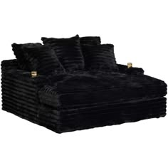 a black couch sitting on top of a white floor